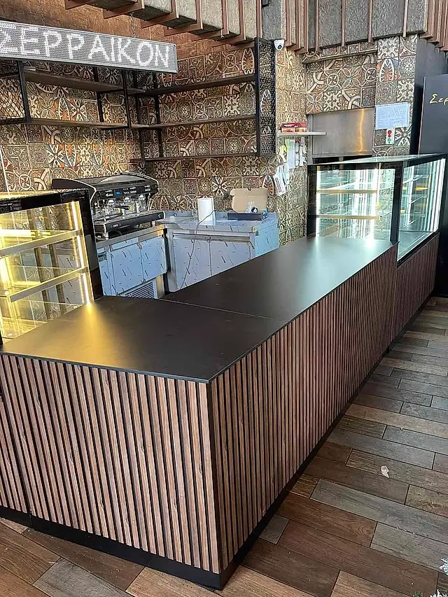 Patisserie: Corner service counter with refrigerated displays
